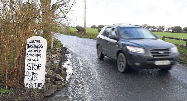 A car drives past Valerie Knight’s wall near Abbeydorney, Co Kerry.