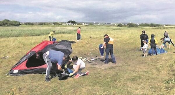 Clean Coast volunteers clean up Adrnahinch Beach after teenagers partied in a sensitive dunes area in a Special Protection Area.