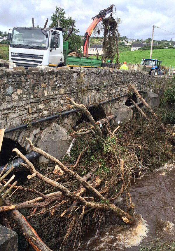 Trees and vehicles in the river Faughan in Drumahoe, Derry. Photo: Niall Carson/PA Wire
