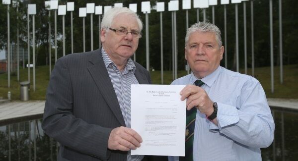 Michael Gallagher (left) who lost his son Aiden, and Stanley McComb (right), who lost his wife Ann in the Omagh bombing hold a writ in the Omagh Memorial Garden. Picture: Niall Carson/PA Wire Michael Gallagher (left) who lost his son Aiden, and Stanley McComb (right), who lost his wife Ann in the Omagh bombing hold a writ in the Omagh Memorial Garden. Picture: Niall Carson/PA Wire