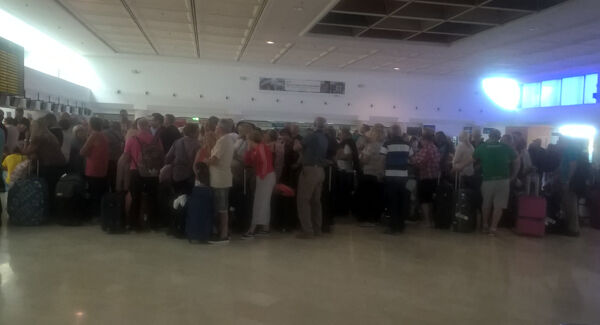 Passengers wait to check in on Monday morning. Picture: John Fagan