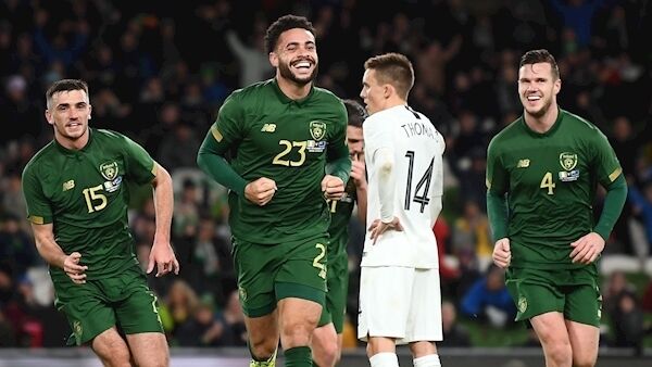 Derrick Williams celebrates after scoring his side's first goal with teammates Troy Parrott, left, and Kevin Long. Photo by Stephen McCarthy/Sportsfile