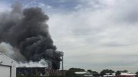 Firefighters battle fire in aircraft hanger in the UK