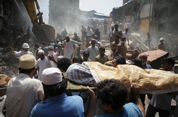 The body of a victim is carried out from the site The body of a victim is carried out from the site
