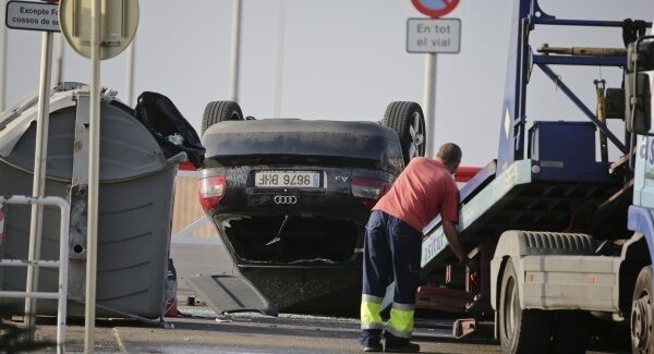 A man loads an overturned car onto a platform at the spot where terrorists were intercepted by police in Cambrils, Spain.
