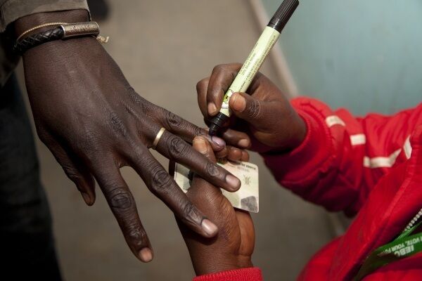 A polling official marks a voter's finger after casting his vote at a polling station in Nairobi. Picture: AP Photo/ Sayyid Abdul Azim