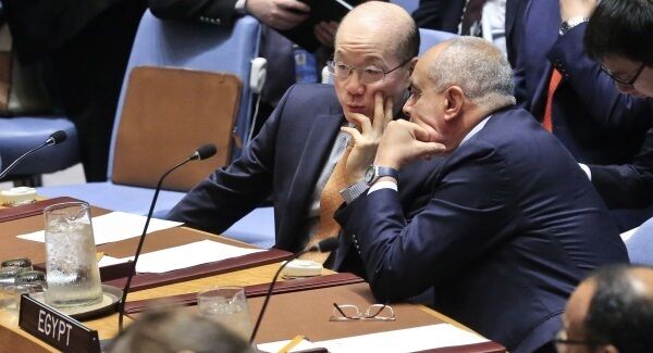 United Nations Ambassadors Liu Jieyi of China, left, and Abdellatif Aboulatta of Egypt, right, confer during the UN Security Council's non-proliferation meeting on North Korea today.