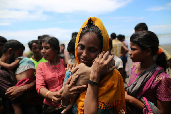 A Rohingya Muslim woman holds an infant child who died when the boat they were traveling in capsized just before reaching the shore of the Bay of Bengal, in Shah Porir Dwip, Bangladesh. Photo by Zakir Hossain Chowdhury/Anadolu Agency/Getty Images A Rohingya Muslim woman holds an infant child who died when the boat they were traveling in capsized just before reaching the shore of the Bay of Bengal, in Shah Porir Dwip, Bangladesh. Photo by Zakir Hossain Chowdhury/Anadolu Agency/Getty Images