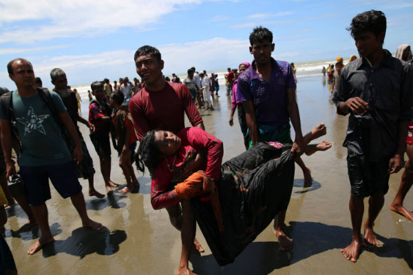 A Rohingya Muslim woman, who crossed over from Burma into Bangladesh, lies unconscious on the shore of Bay of Bangal after the boat she was traveling in capsized at Shah Porir Dwip, Bangladesh. Photo by Zakir Hossain Chowdhury/Anadolu Agency/Getty Images A Rohingya Muslim woman, who crossed over from Burma into Bangladesh, lies unconscious on the shore of Bay of Bangal after the boat she was traveling in capsized at Shah Porir Dwip, Bangladesh. Photo by Zakir Hossain Chowdhury/Anadolu Agency/Getty Images