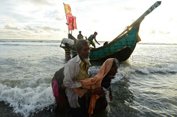 Rohingya refugees disembark from a boat after crossing the border from Burma, on the Bangladeshi shores of the Naf river in Teknaf. Bangladeshi boat operators are exploiting Rohingya Muslims fleeing violence in Burma by demanding up to $100 for ferry trips that usually cost 50 cents. Photo: MUNIR UZ ZAMAN/AFP/Getty Images Rohingya refugees disembark from a boat after crossing the border from Burma, on the Bangladeshi shores of the Naf river in Teknaf. Bangladeshi boat operators are exploiting Rohingya Muslims fleeing violence in Burma by demanding up to $100 for ferry trips that usually cost 50 cents. Photo: MUNIR UZ ZAMAN/AFP/Getty Images