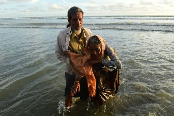 Rohingya refugees wade after crossing the border from Burma by boat, on the Bangladeshi shore of the Naf river in Teknaf. Bangladeshi boat operators are exploiting Rohingya Muslims fleeing violence in Burma by demanding up to $100 for ferry trips that usually cost 50 cents. Photo: MUNIR UZ ZAMAN/AFP/Getty Images Rohingya refugees wade after crossing the border from Burma by boat, on the Bangladeshi shore of the Naf river in Teknaf. Bangladeshi boat operators are exploiting Rohingya Muslims fleeing violence in Burma by demanding up to $100 for ferry trips that usually cost 50 cents. Photo: MUNIR UZ ZAMAN/AFP/Getty Images