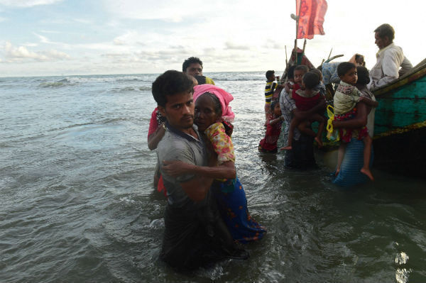 Rohingya refugees disembark from a boat after crossing the border from Burma, on the Bangladeshi shores of the Naf river in Teknaf. Photo: MUNIR UZ ZAMAN/AFP/Getty Images Rohingya refugees disembark from a boat after crossing the border from Burma, on the Bangladeshi shores of the Naf river in Teknaf. Photo: MUNIR UZ ZAMAN/AFP/Getty Images