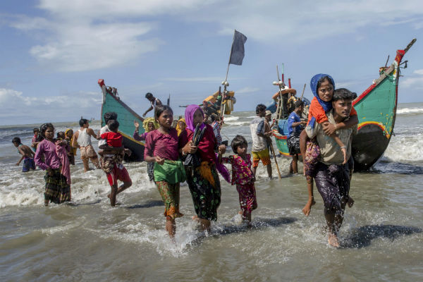 Rohingya Muslims walk to the shore after arriving on a boat from Burma to Bangladesh in Shah Porir Dwip, Bangladesh. AP Photo/Dar Yasin Rohingya Muslims walk to the shore after arriving on a boat from Burma to Bangladesh in Shah Porir Dwip, Bangladesh. AP Photo/Dar Yasin