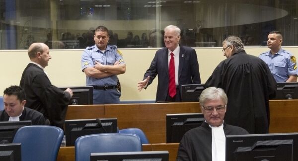 Bosnian Serb military chief Ratko Mladic, center, greets members of his defense team as he enters the Yugoslav War Crimes Tribunal in The Hague, Netherlands this morning Bosnian Serb military chief Ratko Mladic, center, greets members of his defense team as he enters the Yugoslav War Crimes Tribunal in The Hague, Netherlands this morning