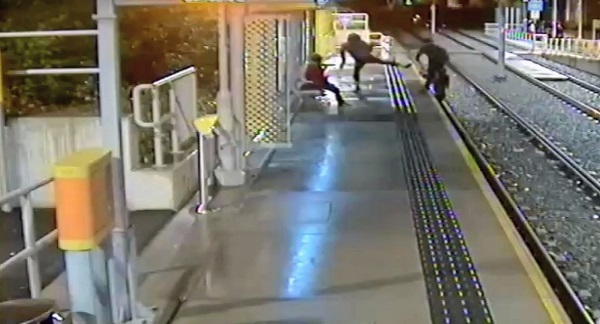 Footage shows man being kicked off platform onto tram tracks