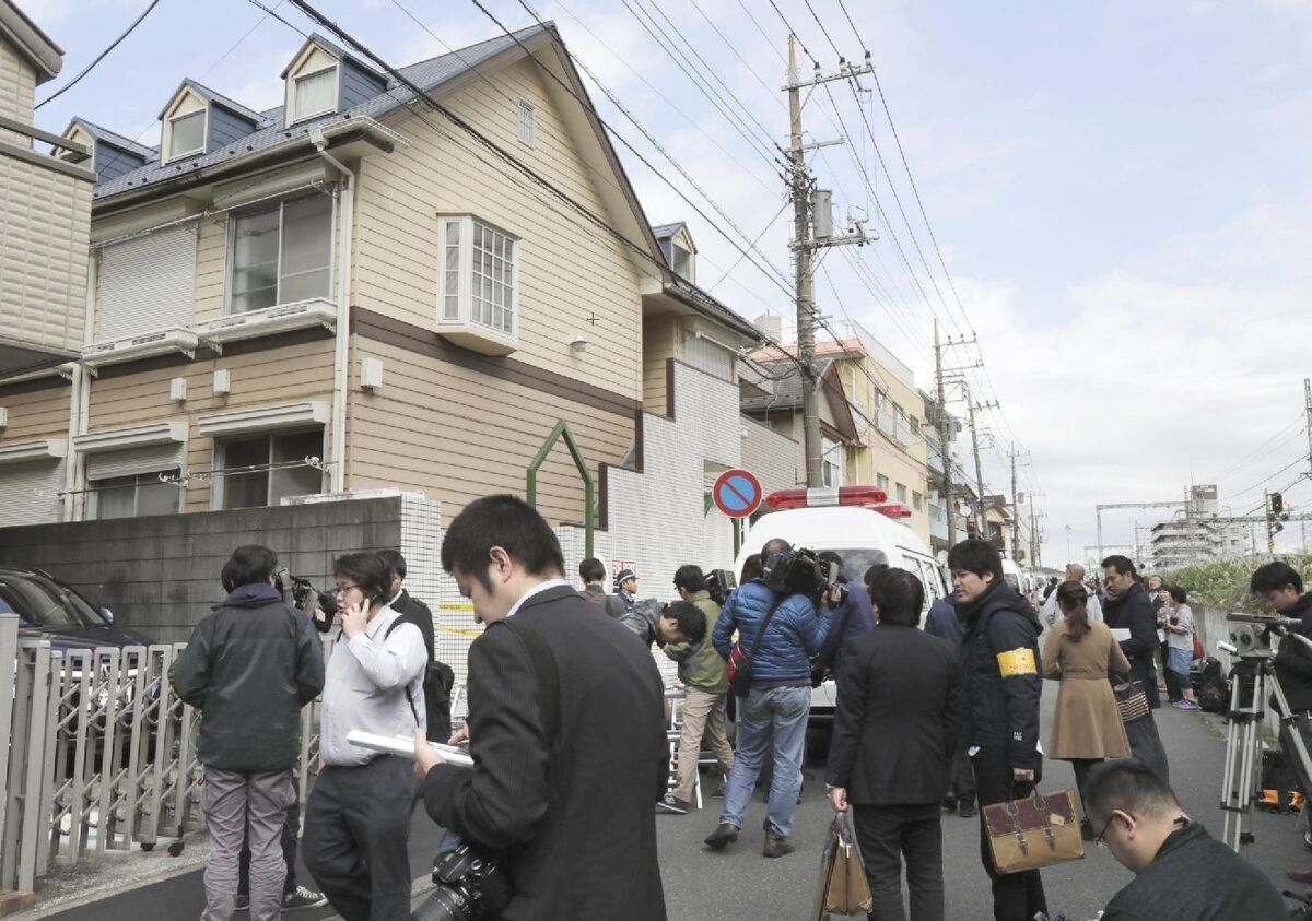 People gather in front of the apartment.