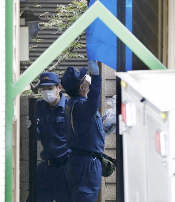Police inspect the apartment where dismembered bodies were found.