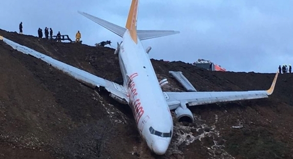 Plane dangles off cliff after skidding off runway in Turkey