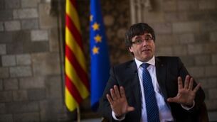 Latest: Catalans urged to peacefully protest as Spain takes direct control