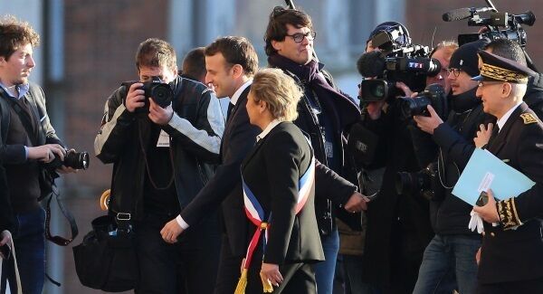 French President Emmanuel Macron with the Mayor of Calais Natacha Bouchart as he arrives at Calais Town Hall in France during a visit to the region.