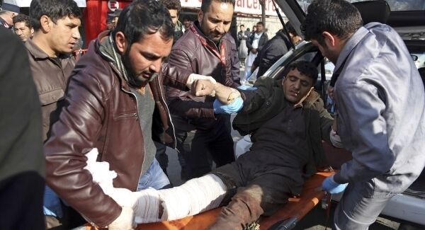 An injured man is moved to a stretcher outside a hospital following a suicide attack in Kabul, Afghanistan.