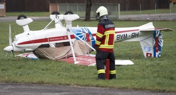 A small airplane lies upside down after a squall topled the plane in Buochs, Switzerland today A small airplane lies upside down after a squall topled the plane in Buochs, Switzerland today