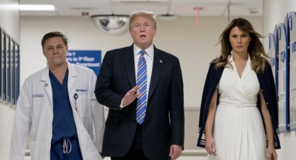 President Donald Trump, center, accompanied by and first lady Melania Trump, right, and Dr. Igor Nichiporenko, left, speak to reporters while visiting with medical staff at Broward Health North in Pompano Beach.