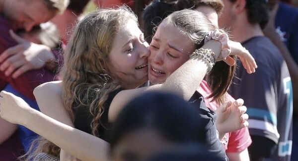 Students comforting each other following school shooting in Florida.