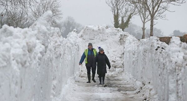 Brother and sister Seamus Ashe and Maureen Sammon look at a trench of snow in Turnings, Straffan Co Kildare as the cold weather continues across the country. Photo: Niall Carson/PA Wire