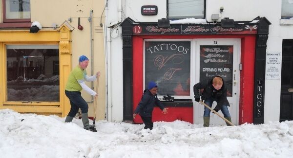Locals take part in clean up in the town of Sallins, Co Kildare after snow storms as the cold weather continues across the country. Photo: Niall Carson/PA Wire
