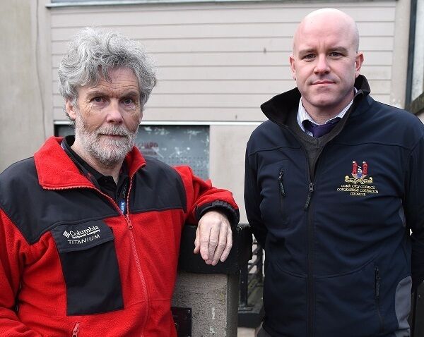 Cork City Council&rsquo;s Pat Duggan and John Kelly, from the housing section, outside a boarded-up property. Picture: Larry Cummins
