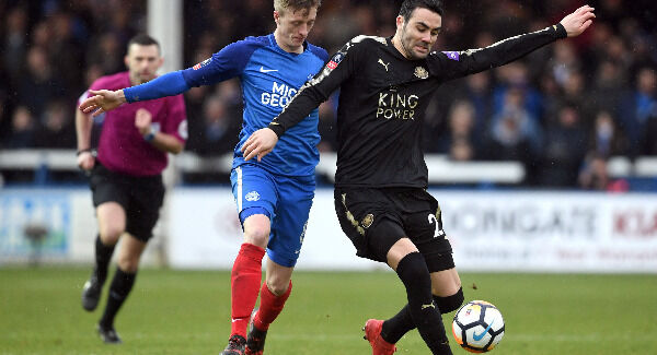 Leicester City's Vicente Iborra and Peterborough United's Chris Forrester (left). Pic: Joe Giddens/PA Wire