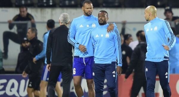 Marseille’s Patrice Evra, center right, is led away by his teammate Rolando after a scuffle with Marseille supporters who trespassed into the field before the Europa League game against Vitoria SC at the D. Afonso Henriques stadium in Guimaraes, Portugal, last week. Pic: AP Photo/Luis Vieira