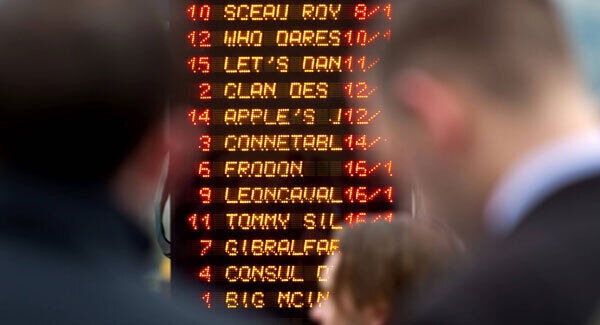 Punters consult the bookmakers odds at Cheltenham day 2 yesterday