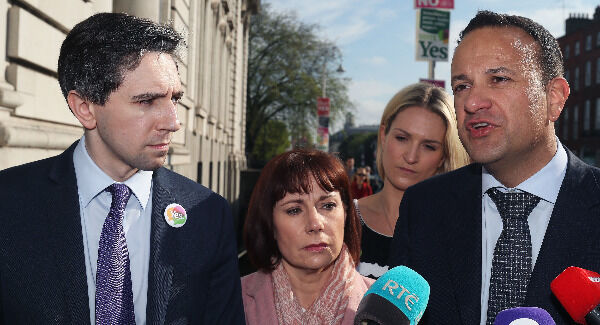 Simon Harris, Josepha Madigan and Leo Varadkar speak to the media outside Government Buildings following a commuter canvass in Dublin's city centre today. Photo: Brian Lawless/PA Wire.
