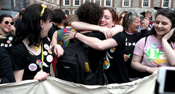 Members of the quartet Voices For Appeal embrace, as they wait at Dublin Castle for the result of the referendum. Pic: Niall Carson/PA Wire.