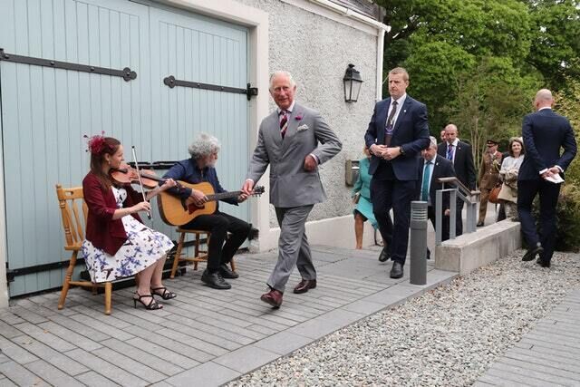 The royal couple pass a pair of musicians (Niall Carson/PA) The royal couple pass a pair of musicians (Niall Carson/PA)