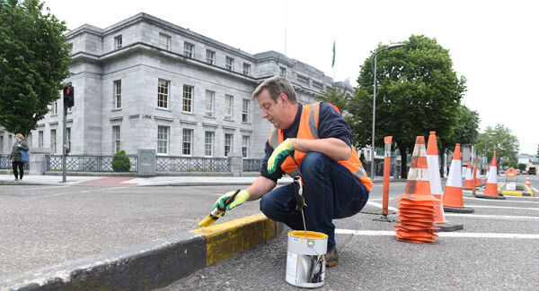 Kevin Linehan, Cork City Council, painting road curbs outside City Hall.