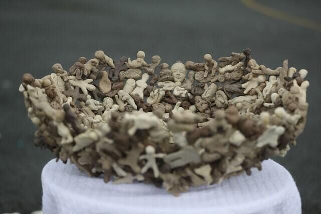 A bowl made up of clay child figurines (Niall Carson/PA)