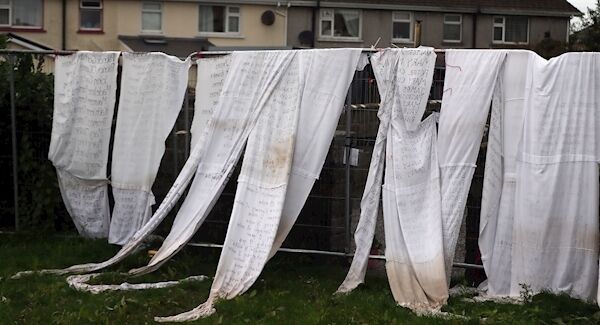Bed sheets with names of deceased children tied to the fence of the former Tuam home for unmarried mothers. Picture: Niall Carson/PA Wire
