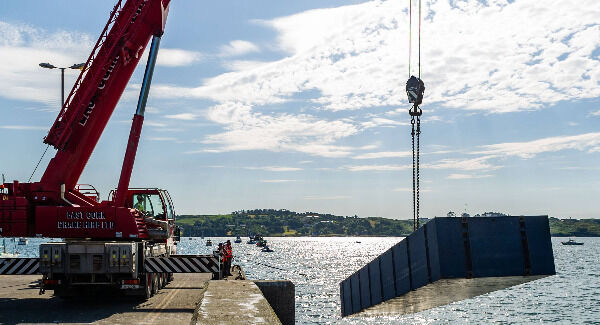 Contractors lift a section of the new pontoon into the water in Schull Harbour. Photo: Andy Gibson