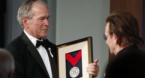 Former President George W. Bush, left, presents a medal of Distinguished Leadership to U2 musician Bono during a gala for the Forum on Leadership at the George W. Bush Institute, Thursday, April 19, 2018, in Dallas. (AP Photo/Brandon Wade)