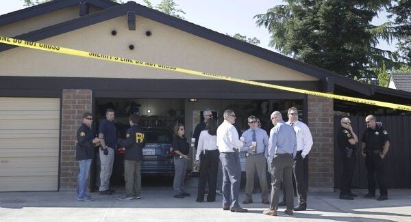 Authorities gather outside the home of suspect Joseph James DeAngelo, Wednesday, April 25, 2018, in Citrus Heights, California.