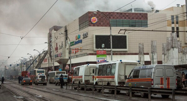 Smoke rises above the multi-story shopping centre. Photo: AP Photo/Sergei Gavrilenko