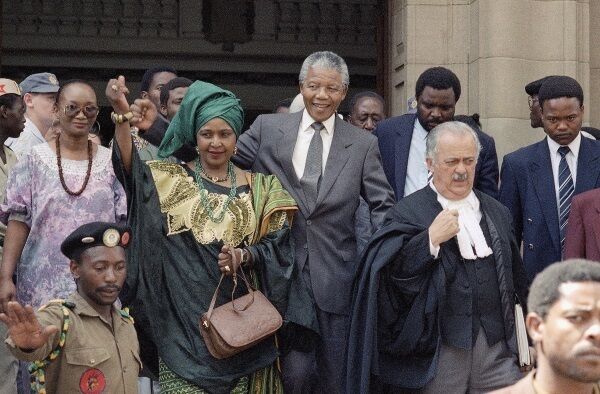 Winnie Mandela, centre left, wife of African National Congress leader Nelson Mandela, centre right, leaves the Rand Supreme Court after an adjournment of her kidnap and assault court case.