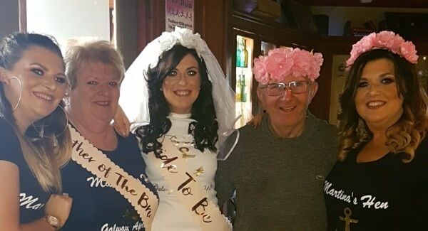 Martina with her Mam Elsie, Dad Christy (wearing the flower crown), and sisters Laura and Corina.