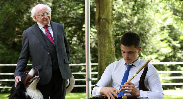 President Michael D Higgins with his dog Brod listen to piper Cormac Keegan at Aras an Uachtarain. Pic: Sam Boal/Rollingnews.ie