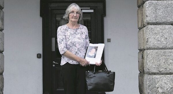 Shane's mother, Lucia, holding a picture of her late son
