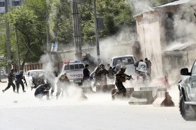 Security forces run from the scene of the second bombing in Kabul (Massoud Hossaini/AP)