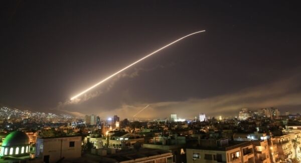 Damascus skies erupt with missile fire as the U.S. launches an attack on Syria targeting different parts of the capital Syria, early Saturday, April 14, 2018. Syria's capital has been rocked by loud explosions that lit up the sky with heavy smoke as U.S. President Donald Trump announced airstrikes in retaliation for the country's alleged use of chemical weapons. (AP Photo/Hassan Ammar)